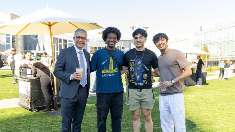 President Aceves posing with students