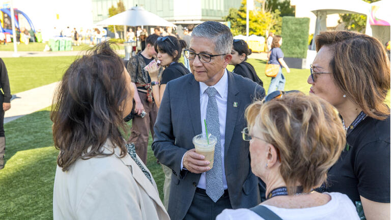President Aceves talking with arts and sciences faculty and staff