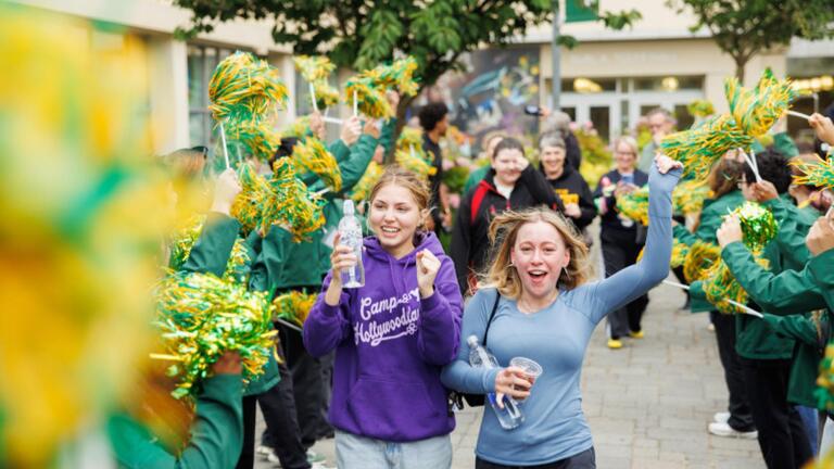 Students cheering with pom poms.