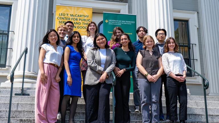 students stand in front of a building