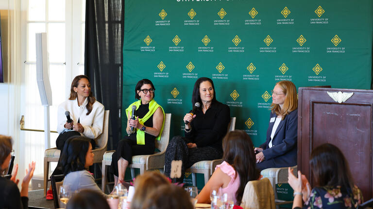Four panelists on stage at the WILP Symposium