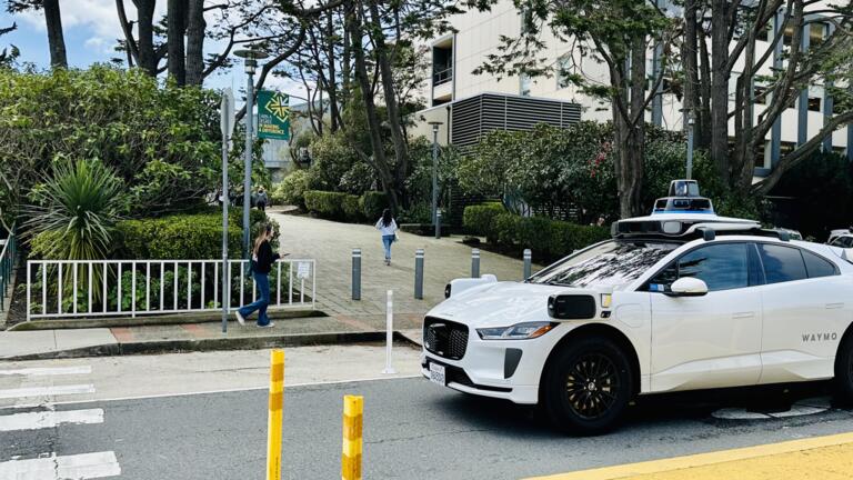 Waymo vehicle driving through campus
