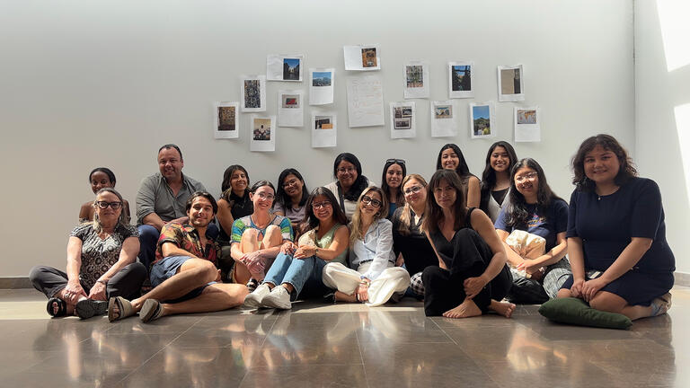 group of students sit on ground
