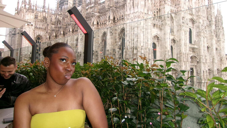 Student sits outside the Milan Cathedral