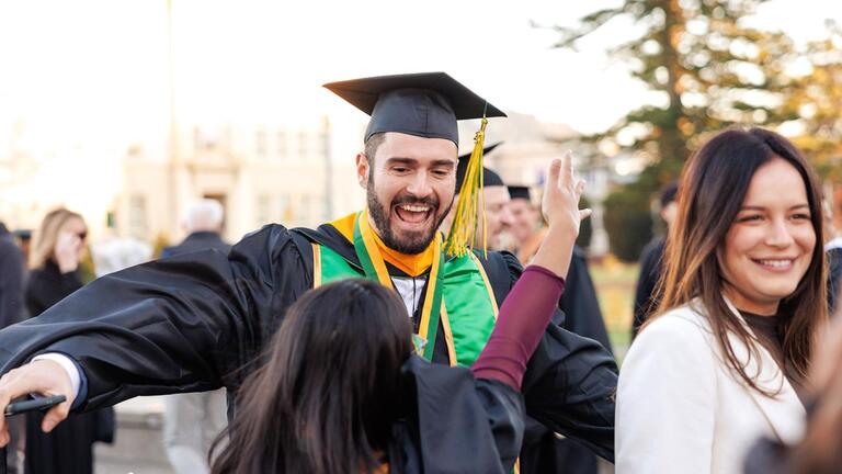 school of management student celebrates his graduation