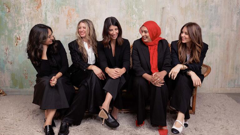 five women sitting next to each other