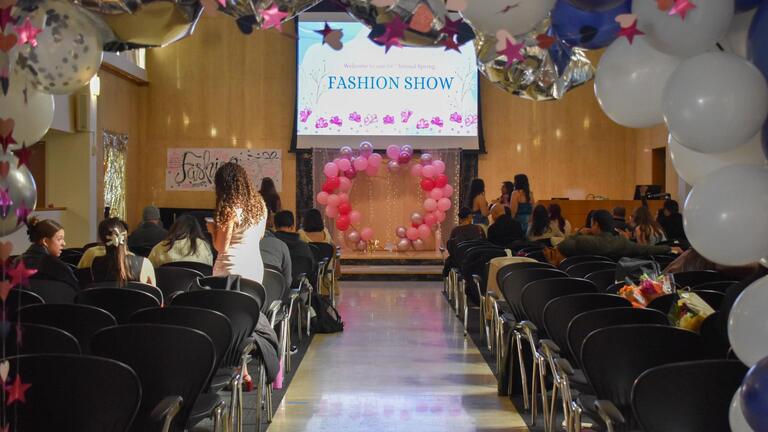 The walk-way of Fashion Show with students sitting on both sides