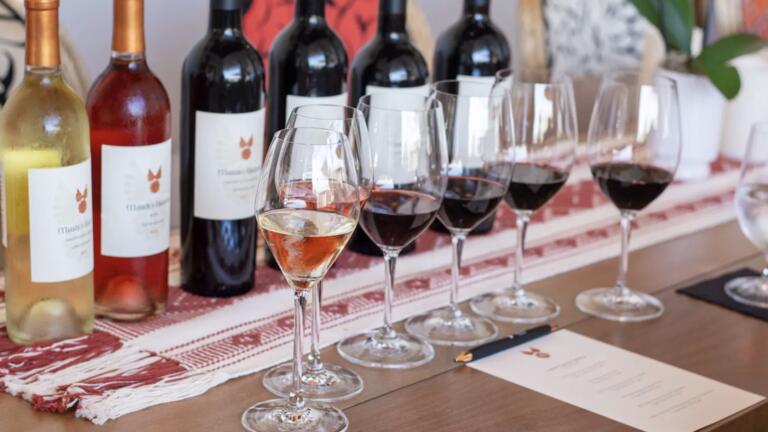 Bazan Cellars Tasting Room with bottles and glasses of wine with a tasing menu