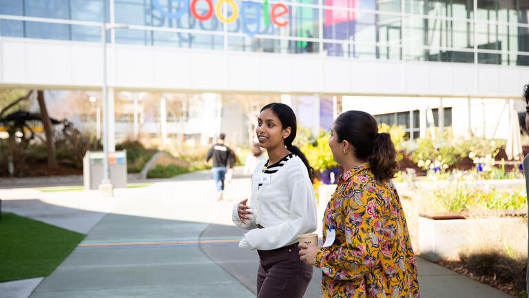 Two USF students walking outside the Google office