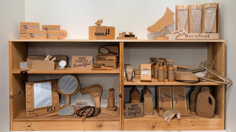 Cardboard art of a stocked shelf in a store