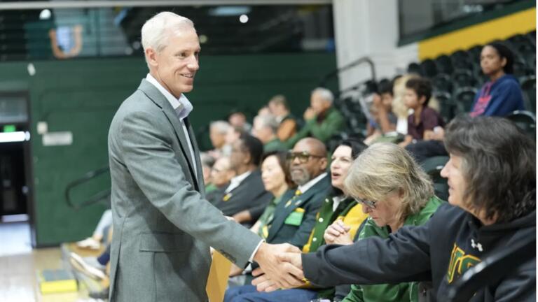 Athletic Director, Brent Blaylock shaking hands with people