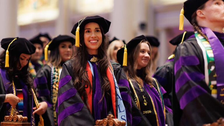 Law school graduates in cap and gown in St. Ignatius church