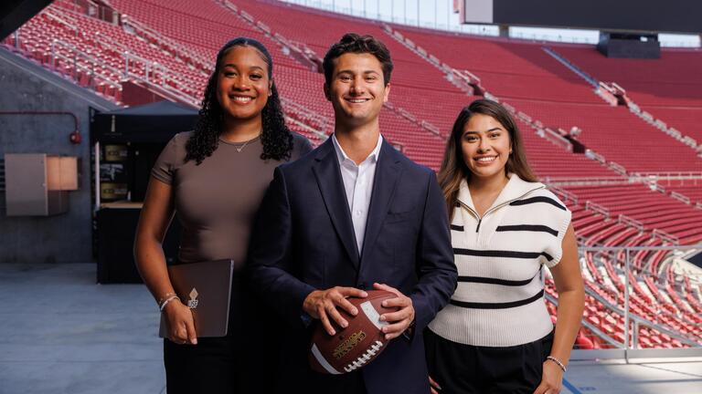 Sport management members standing in a stadium 