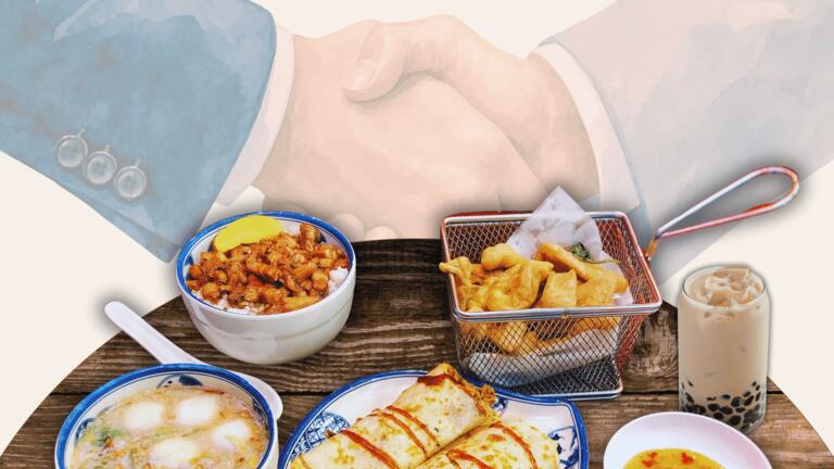 Several Taiwanese dishes in the foreground. Handshake in the background. 