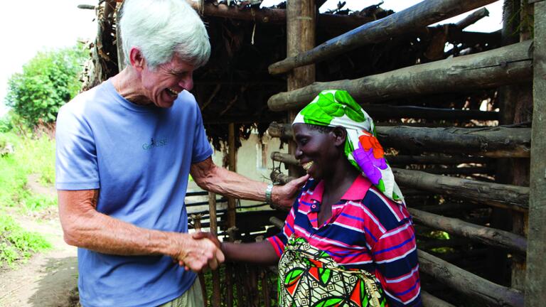 Fr. Privett discussing income-generating projects with Veronique Kayoya, a resident of Busekera village. 