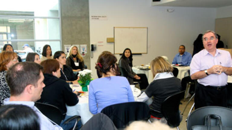 Interim Dean conducts meeting with the School of Management staff