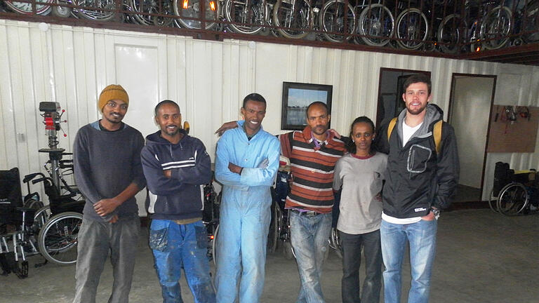 Justin Grider MS '14 (right) at a wheelchair repair shop during a two-month economic development research trip to Addis Adaba, Ethiopia.