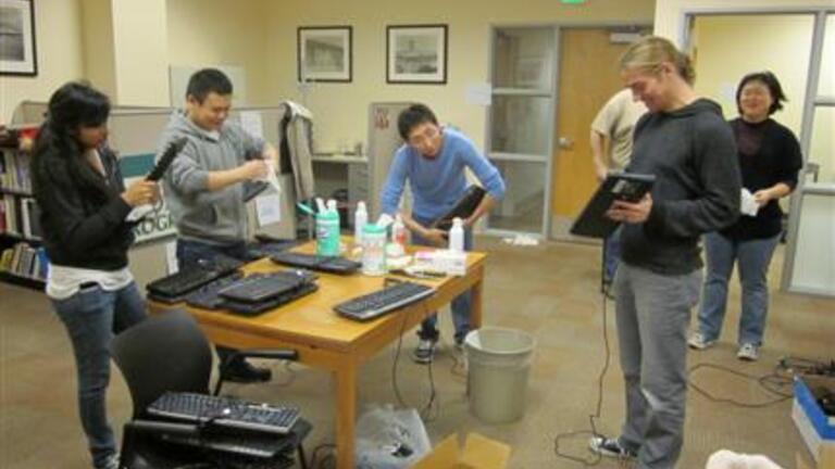 USF students help install and maintain computer equipment at the Tenderloin Tech Lab.