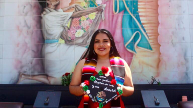 Ashley Perez holding a graduation cap