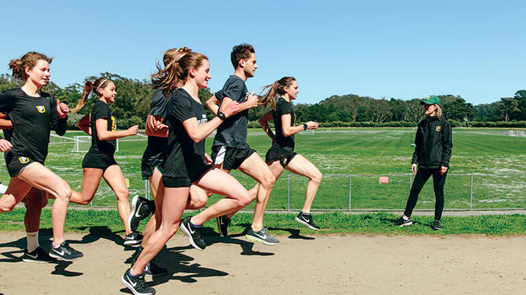 Cross-country teams run on track as Coach Helen Lehman-Winters watches
