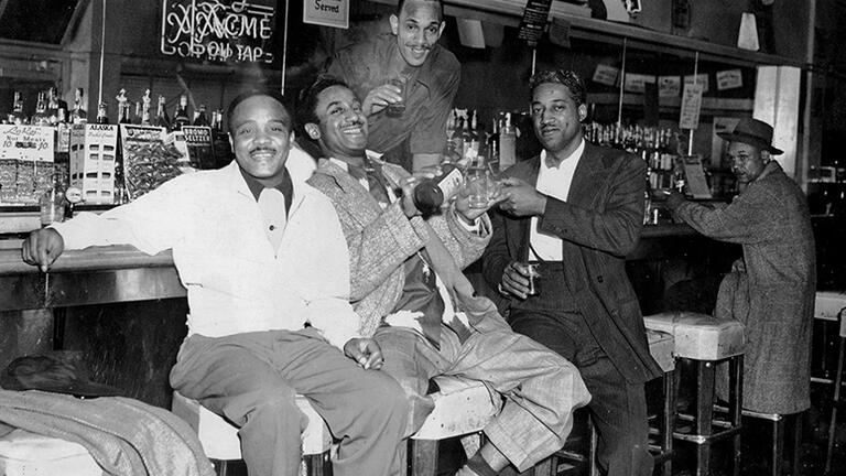 Historical image of a group seated at Fillmore bar