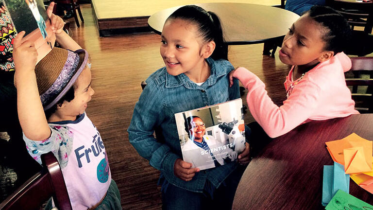 Children holding books they wrote