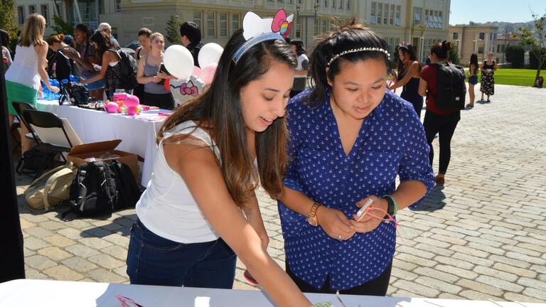 Students browse the Hello Kitty-themed photo booth props