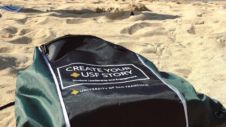 USF branded backpack laying on the beach