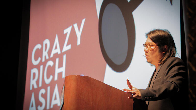 Author Kevin Kwan at podium sharing stories with audience