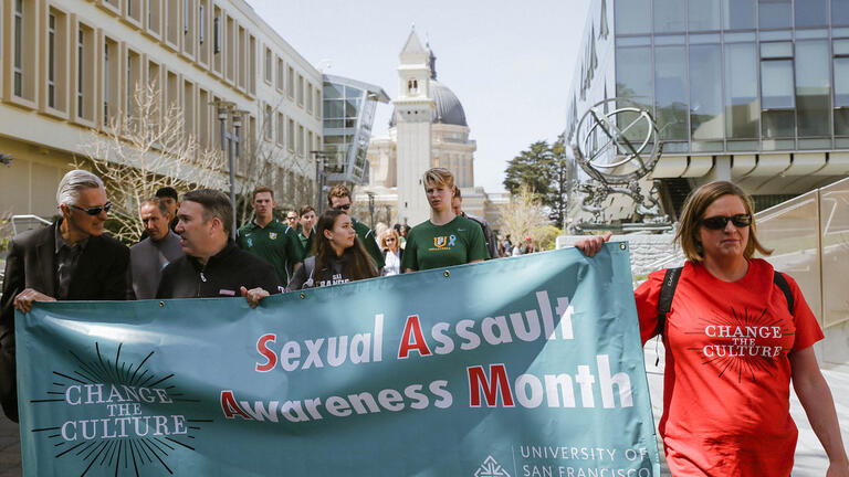 USFers holding a banner that reads: Change the Culture. Sexual Assault Awareness Month.
