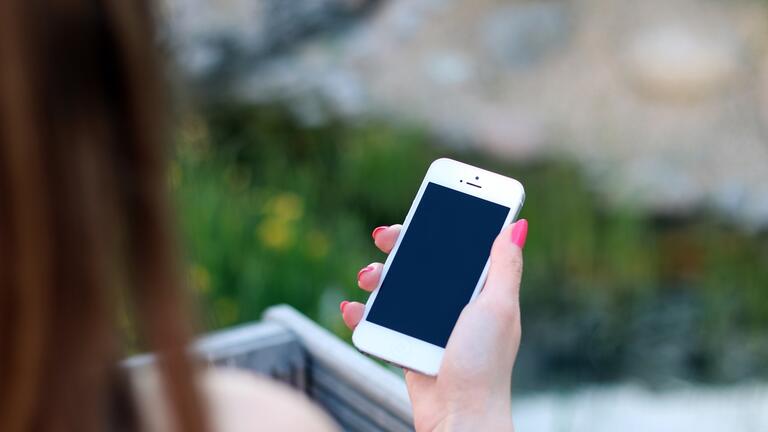 Student holds an Apple device