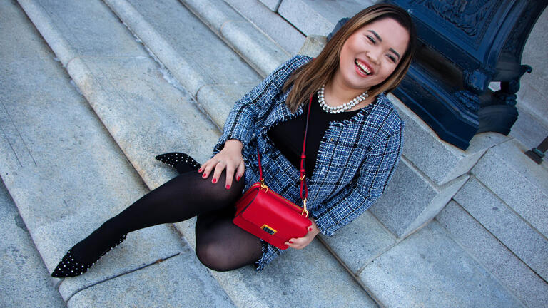 Akiko Bates '19 shows off one of Mei Li's purses