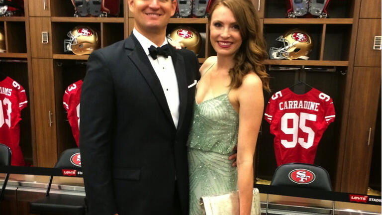 Atkinson, ’14, and her husband in the San Francisco 49ers locker room at the Levi’s Stadium Opening Gala, July 2014