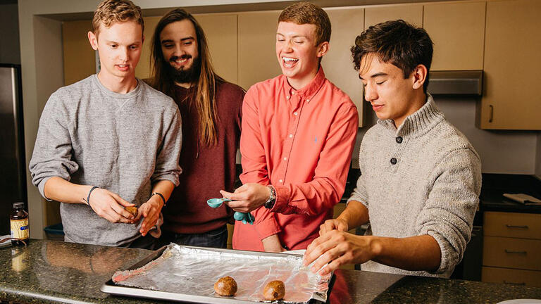 Cookie Bros club adding dough to cookie sheet