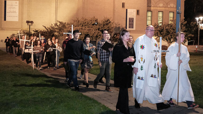 Fr. Godfrey leading a procession from St. Ignatius Church to the memorial site. (Photo credit: Dennis Callahan, Catholic San Francisco)