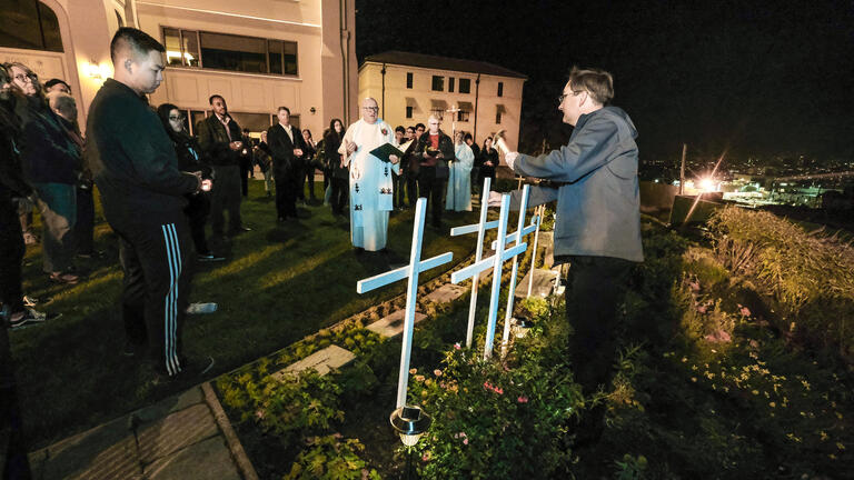 Members of the procession erect wooden crosses painted with each martyr’s name.