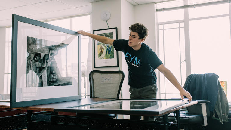 Kevin Clark '15 prepares an exhibit for the Foster Youth Museum. 