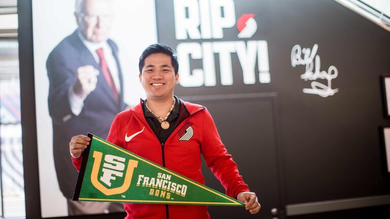 Keoki Kakigi holding USF pennant