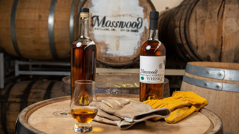 Mosswood barrels and whiskey bottles