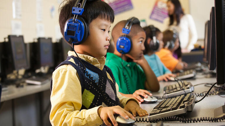 Young kids using computers