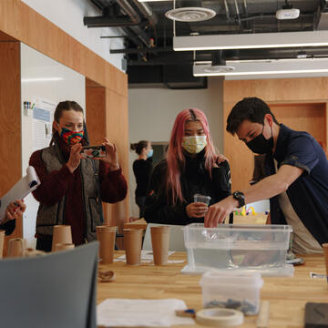 Students work on an experiment with machines in Engineering class.