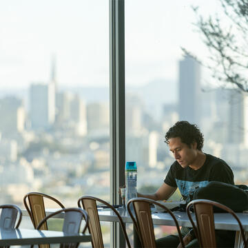 Student studies at a table in Lone Mountain cafeteria