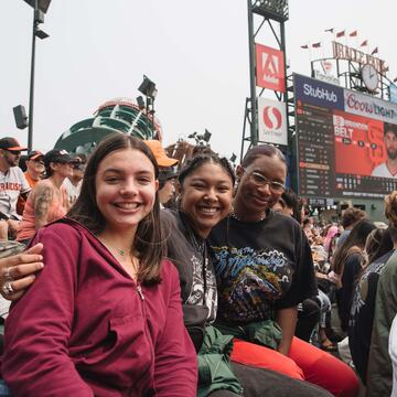 Students posing in the stands at an SF Giants game at Oracle Park.