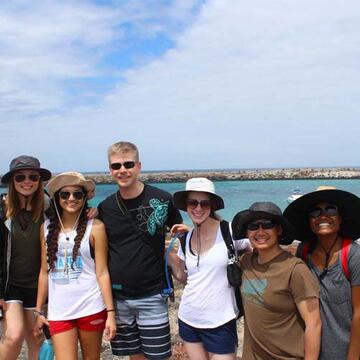professor sikes and students on the beach