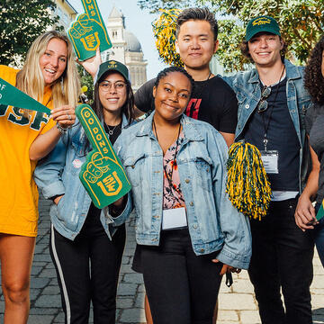 Students holding university swag