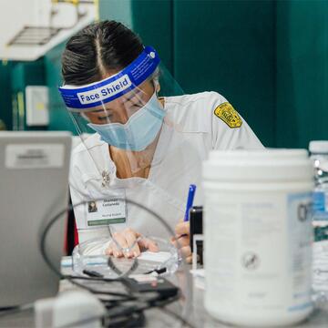 Nursing student works with vaccine supplies