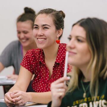 Students listen to their professor in a classroom.