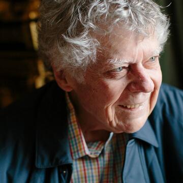 Gordon Getty gazes towards the right and smiles