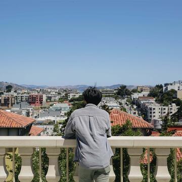 Student looks at the city from a view on Lone Mountain.