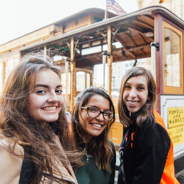 A group of students in front of a cable car.